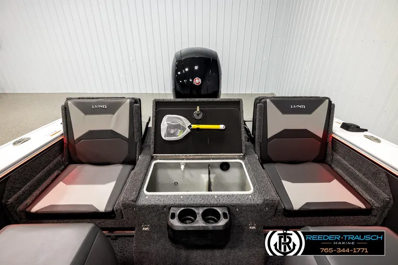 Slide: The Image of 2026 Lund 1875 Crossover XS boat interior with seating and storage compartments. - 19