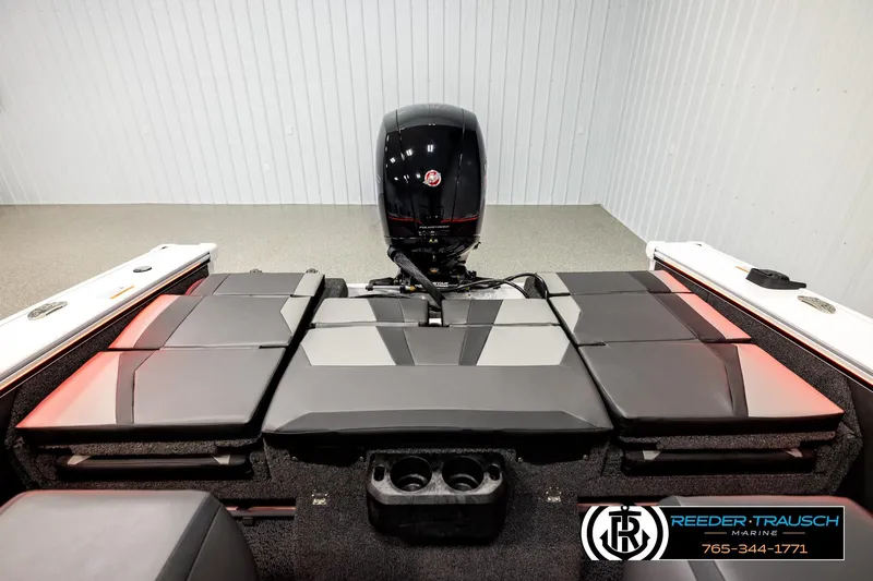 Slide: The Image of 2026 Lund 1875 Crossover XS boat interior with cushioned seating and outboard motor. - 21