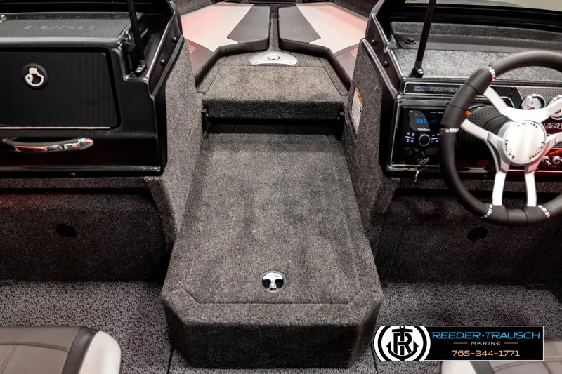 Slide: The Image of 2026 Lund 1875 Crossover XS boat interior with steering wheel and dashboard details. - 22