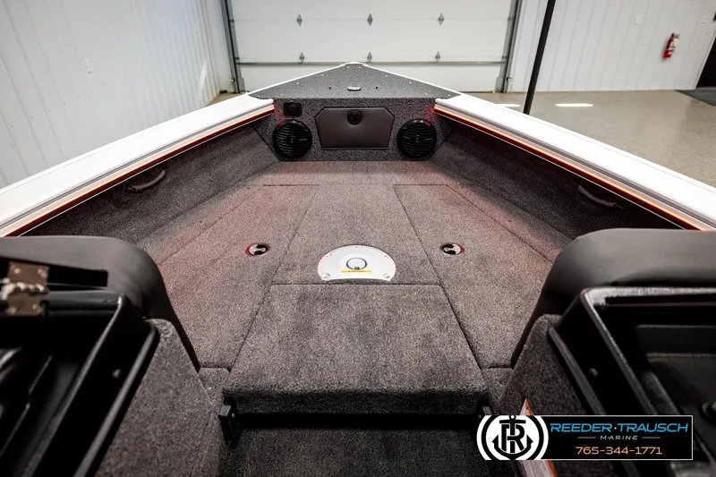 Slide: The Image of Interior view of 2026 Lund 1875 Crossover XS boat, featuring spacious carpeted deck. - 26