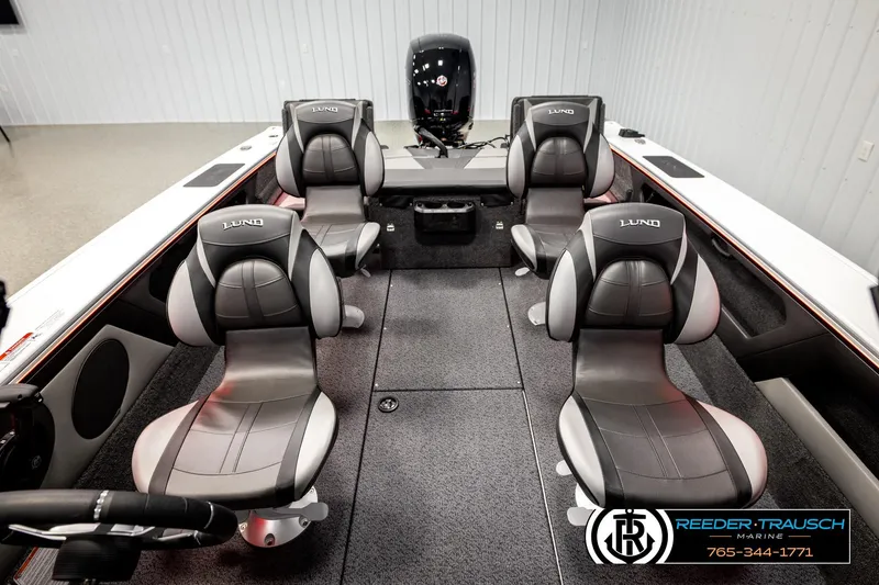 Slide: The Image of 2026 Lund 1875 Crossover XS boat interior with four seats and steering wheel. - 29