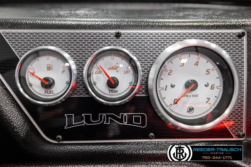 Slide: The Image of Dashboard gauges of 2026 Lund 1875 Crossover XS boat, featuring fuel, trim, and RPM indicators. - 39