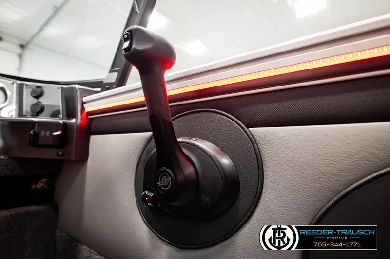 Slide: The Image of Interior view of 2026 Lund 1875 Crossover XS boat with control lever and LED lighting. - 44