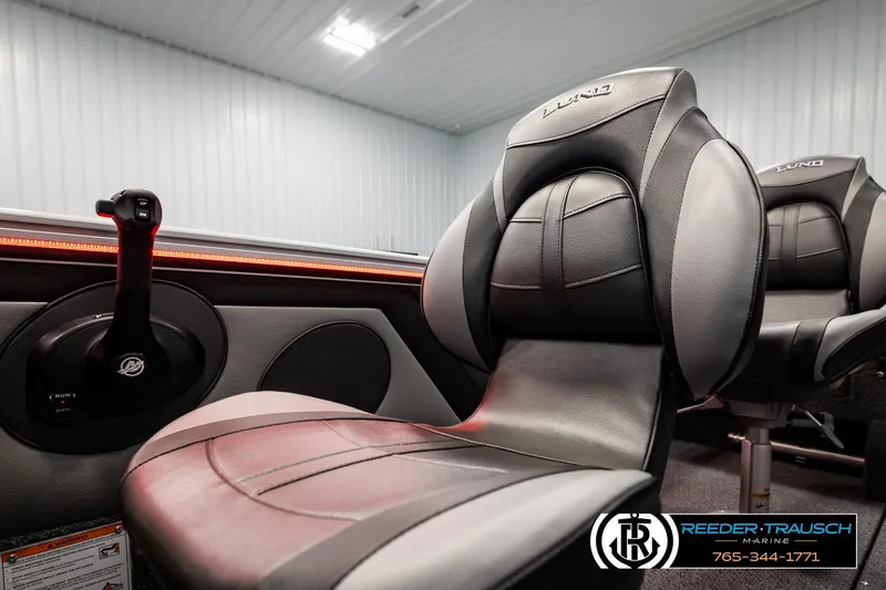 Slide: The Image of 2026 Lund 1875 Crossover XS boat interior with sleek seating and control panel. - 45