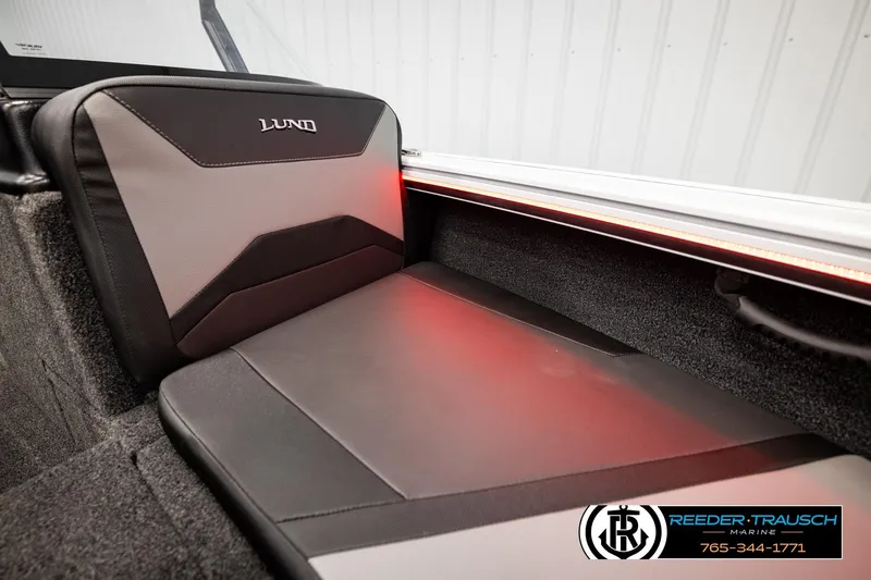 Slide: The Image of 2026 Lund 1875 Crossover XS boat interior with cushioned seating and ambient lighting. - 47