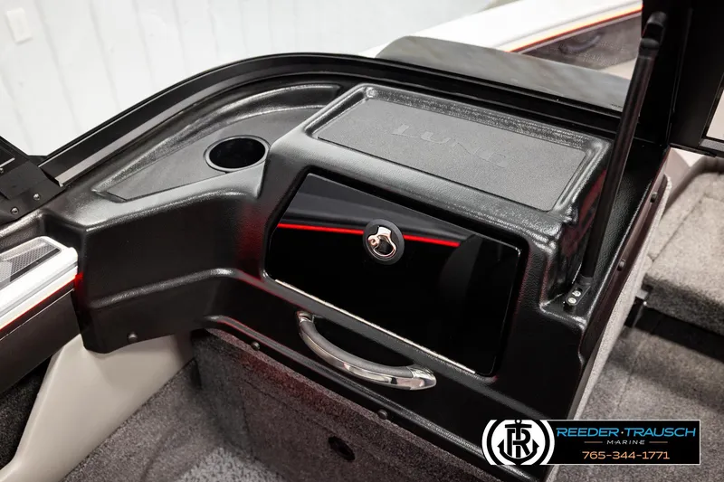 Slide: The Image of Interior of 2026 Lund 1875 Crossover XS boat, featuring storage compartment and cup holder. - 50