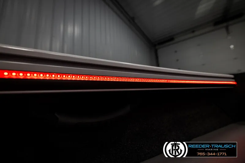 Slide: The Image of 2026 Lund 1875 Crossover XS boat with sleek red LED lighting detail. - 51