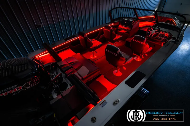 Slide: The Image of 2026 Lund 1875 Crossover XS boat interior with red LED lighting. - 56