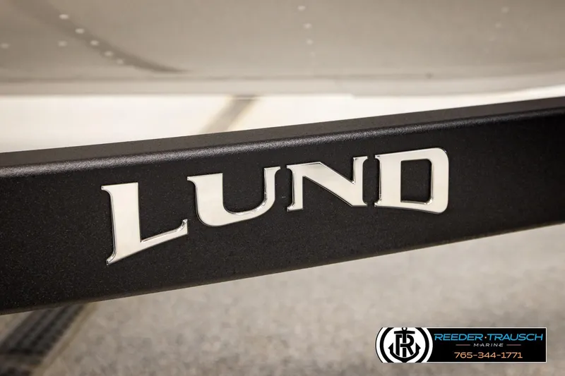 Slide: The Image of Close-up of Lund logo on 2026 Lund 1875 Crossover XS boat trailer. - 60
