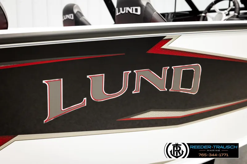 Slide: The Image of 2026 Lund 1875 Crossover XS boat with bold logo and sleek design. - 61