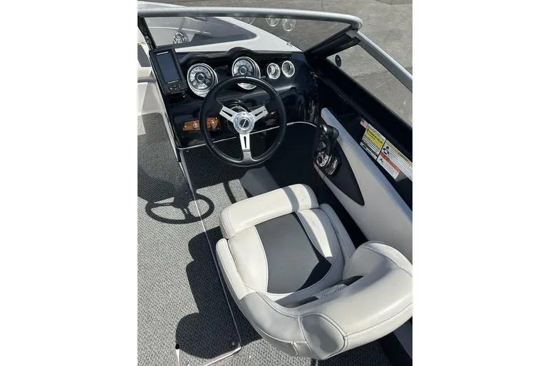 Slide: The Image of Interior of 2015 Glastron GT 185 boat showing steering wheel and dashboard controls. - 10