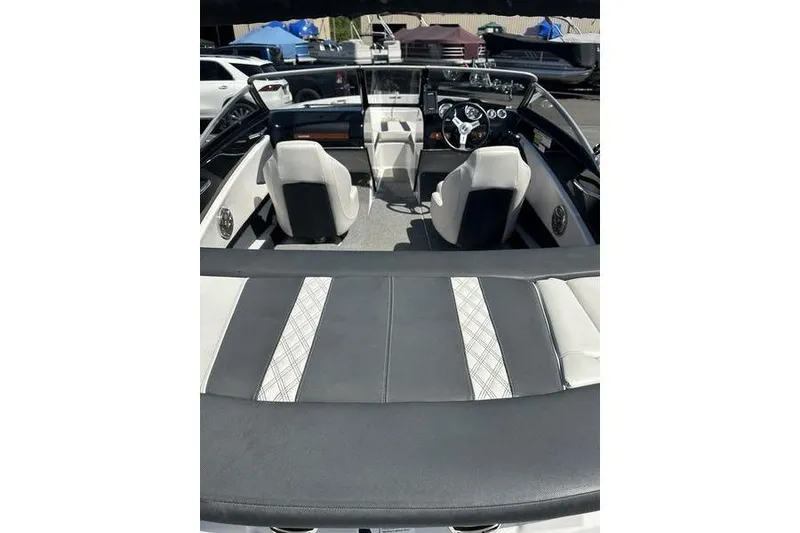Slide: The Image of 2015 Glastron GT 185 boat interior with seating and dashboard view. - 11