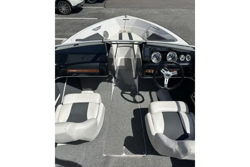 Slide: The Image of Interior view of 2015 Glastron GT 185 boat with steering wheel and seating. - 13