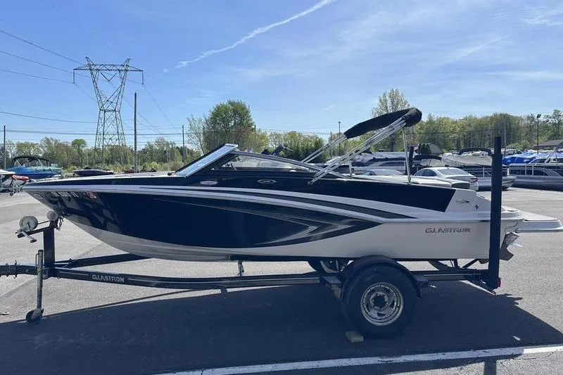 Slide: The Image of 2015 Glastron GT 185 boat on trailer in outdoor setting. - 15
