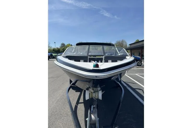 Slide: The Image of 2015 Glastron GT 185 boat on trailer under clear blue sky. - 3
