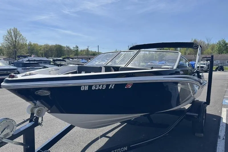 Slide: The Image of 2015 Glastron GT 185 boat on trailer in sunny parking lot. - 4