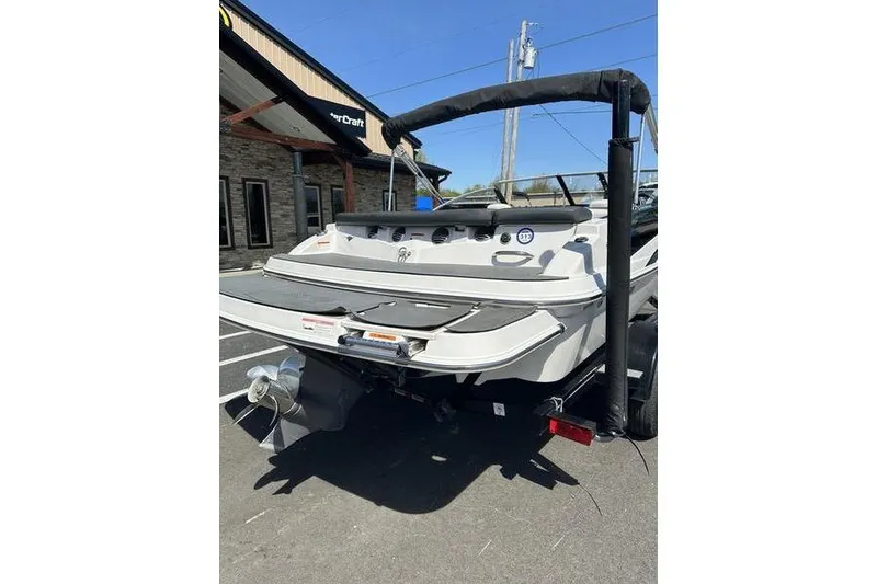 Slide: The Image of 2015 Glastron GT 185 boat rear view in parking lot, sunny day. - 6