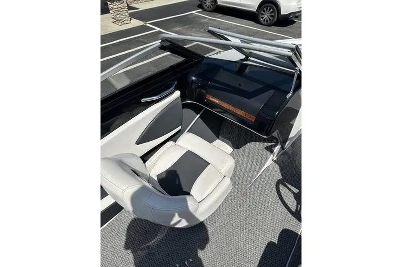 Slide: The Image of Interior of a 2015 Glastron GT 185 boat with white and black seating. - 8