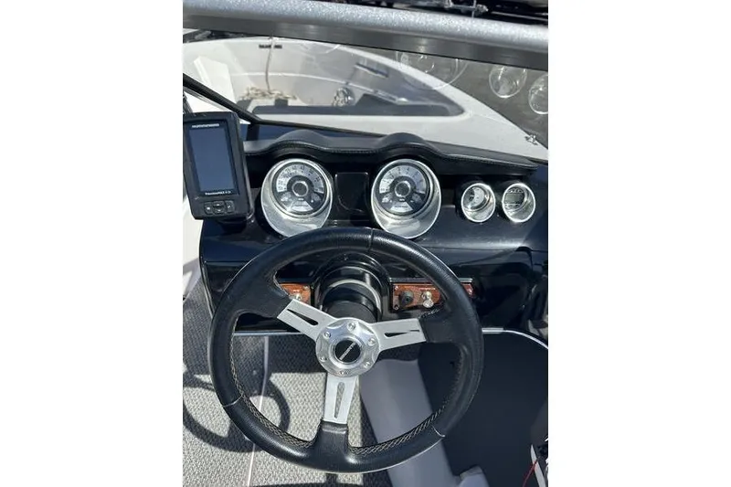 Slide: The Image of Steering wheel and dashboard of a 2015 Glastron GT 185 boat. - 9