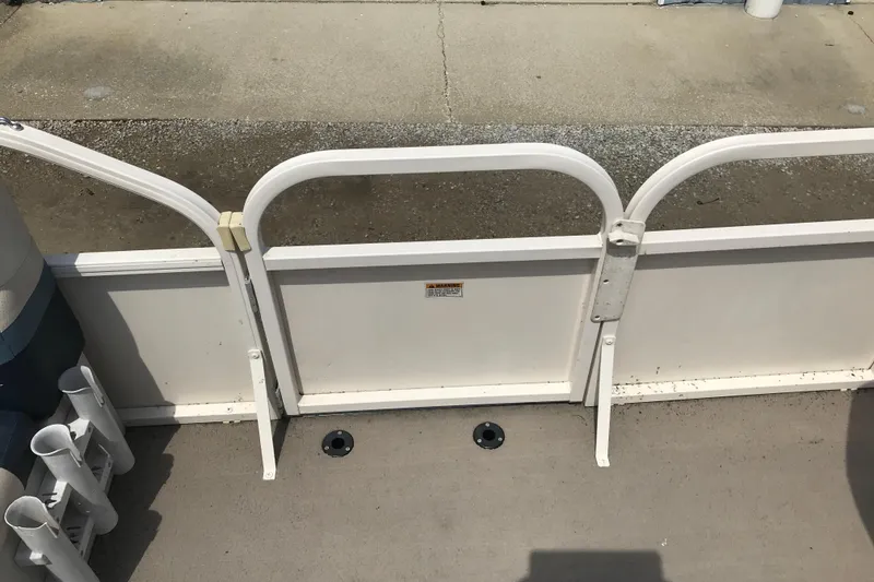 Slide: The Image of 2007 Starcraft Classic 200 CR boat deck with railing and rod holders. - 15