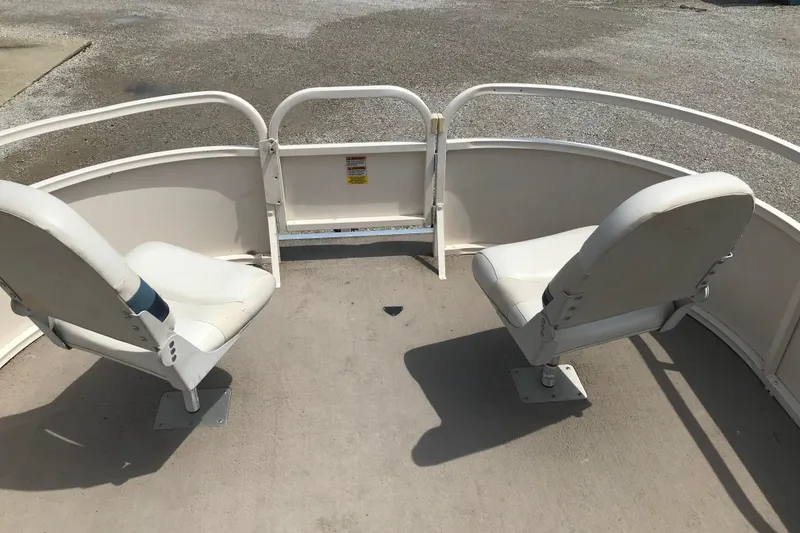 Slide: The Image of 2007 Starcraft Classic 200 CR boat interior with two white swivel seats. - 16