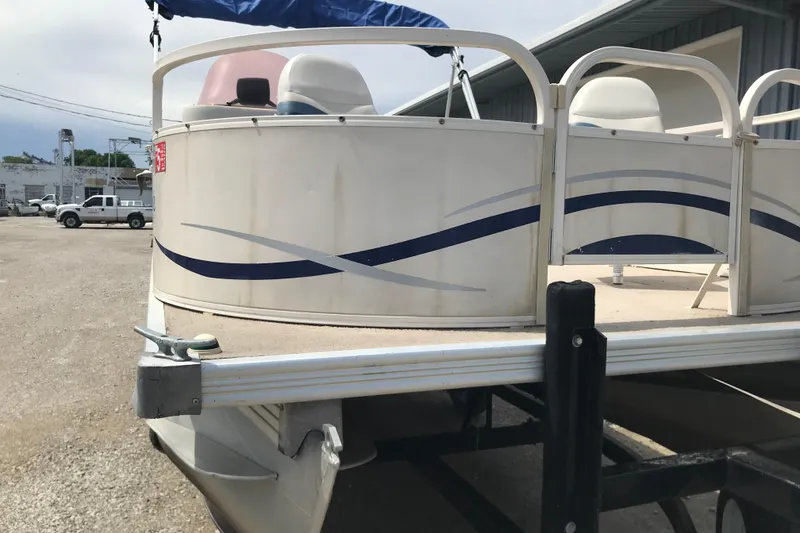 Slide: The Image of 2007 Starcraft Classic 200 CR pontoon boat on trailer, parked outdoors. - 17