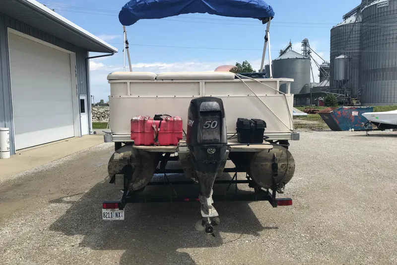 Slide: The Image of 2007 Starcraft Classic 200 CR pontoon boat with outboard motor and fuel tanks. - 2