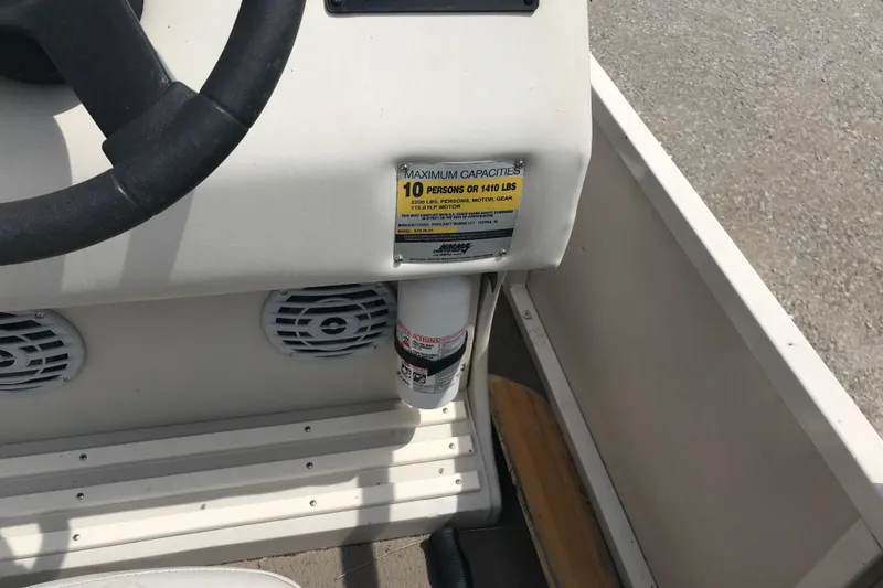 Slide: The Image of 2007 Starcraft Classic 200 CR boat dashboard with capacity label and steering wheel. - 8