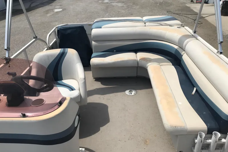 Slide: The Image of 2007 Starcraft Classic 200 CR boat interior with worn seating and steering console. - 9