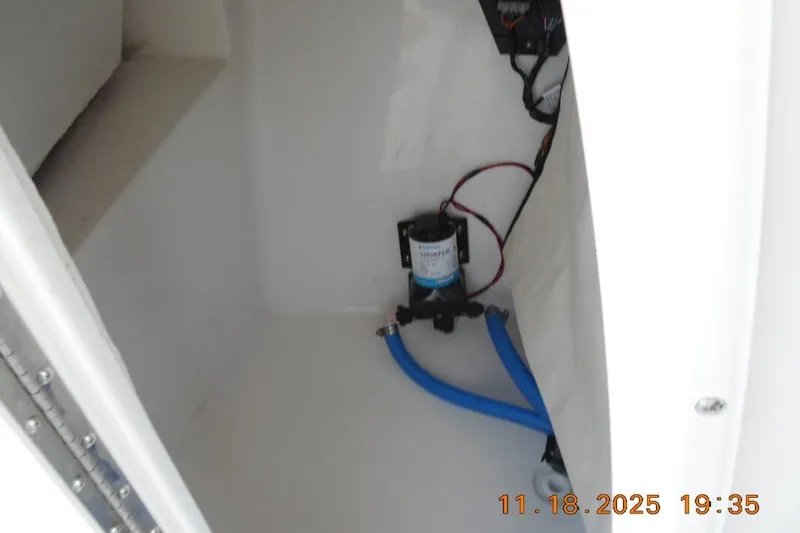 Slide: The Image of Interior view of 2026 Sea Fox 228 Traveler boat compartment with pump and wiring. - 17