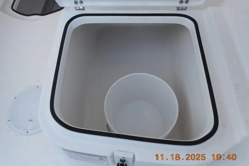 Slide: The Image of Open storage compartment on 2026 Sea Fox 228 Traveler boat with a bucket inside. - 20