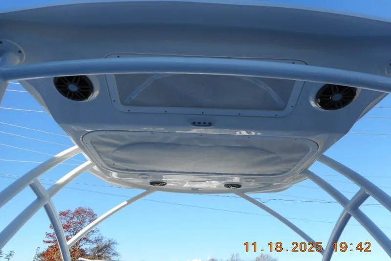 Slide: The Image of T-top of 2026 Sea Fox 228 Traveler boat with speakers, under clear blue sky. - 23