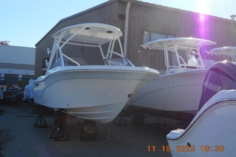 Slide: The Image of 2026 Sea Fox 228 Traveler boats displayed outdoors near a warehouse. - 3