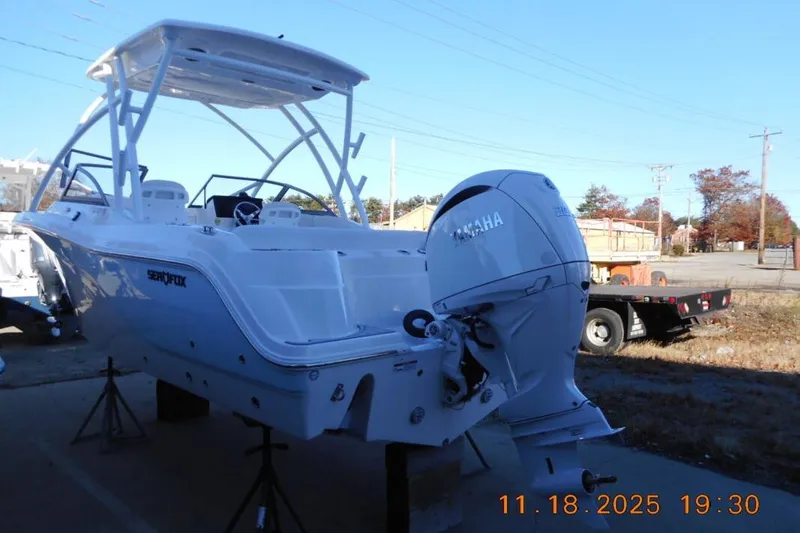 Slide: The Image of 2026 Sea Fox 228 Traveler boat with Yamaha engine, displayed outdoors on stands. - 5