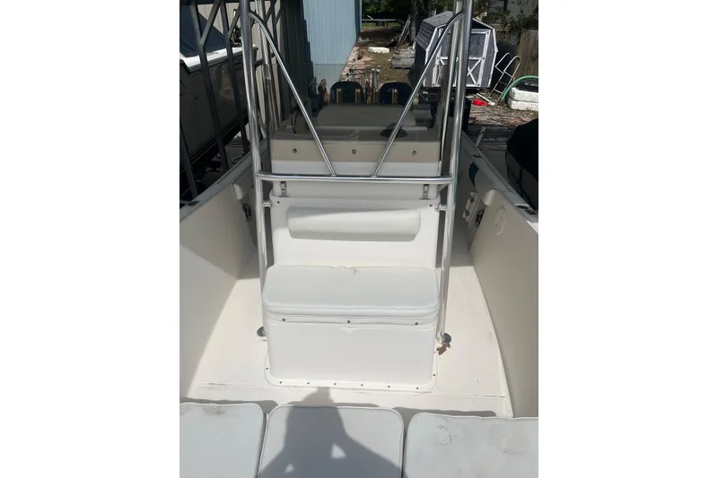 Slide: The Image of 1998 Pursuit 2470 Center Console boat interior with seating and storage. - 10