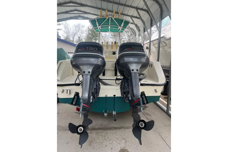 Slide: The Image of 1998 Pursuit 2470 Center Console boat with twin Yamaha V130 outboard motors in a covered storage. - 15