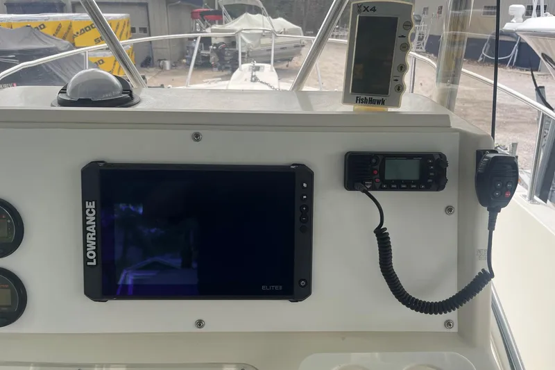 Slide: The Image of 1998 Pursuit 2470 Center Console dashboard with Lowrance and FishHawk electronics. - 6