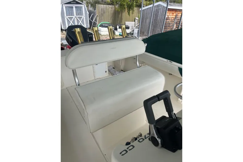 Slide: The Image of 1998 Pursuit 2470 Center Console boat interior with white seating and control panel. - 7