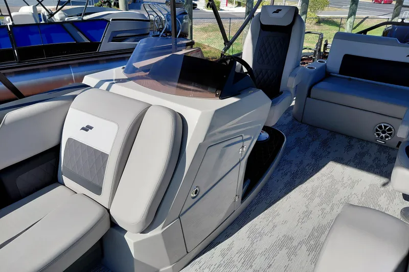 Slide: The Image of 2026 Starcraft SLS 3 Q DH boat interior with modern seating and sleek dashboard design. - 16