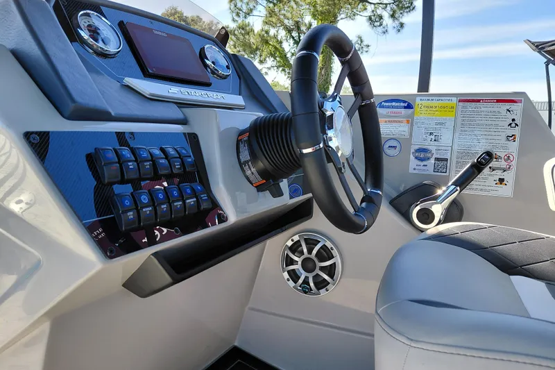 Slide: The Image of 2026 Starcraft SLS 3 Q DH boat dashboard with steering wheel and control panel. - 18
