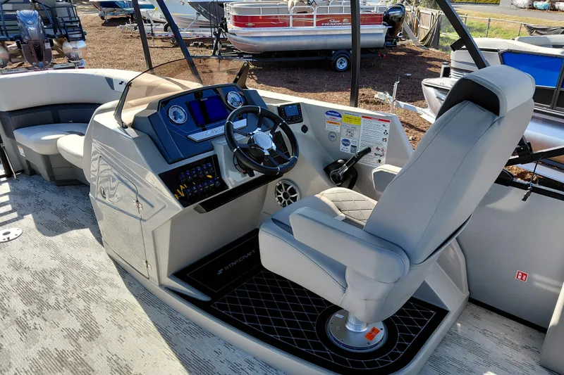 Slide: The Image of 2026 Starcraft SLS 3 Q DH boat interior with modern helm and comfortable seating. - 22