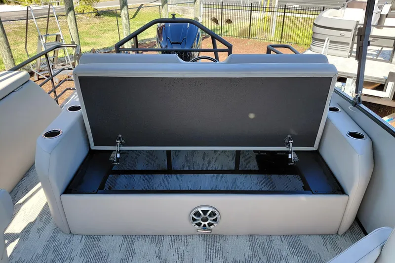Slide: The Image of Open storage compartment on 2026 Starcraft SLS 3 Q DH boat with cup holders and speaker. - 25