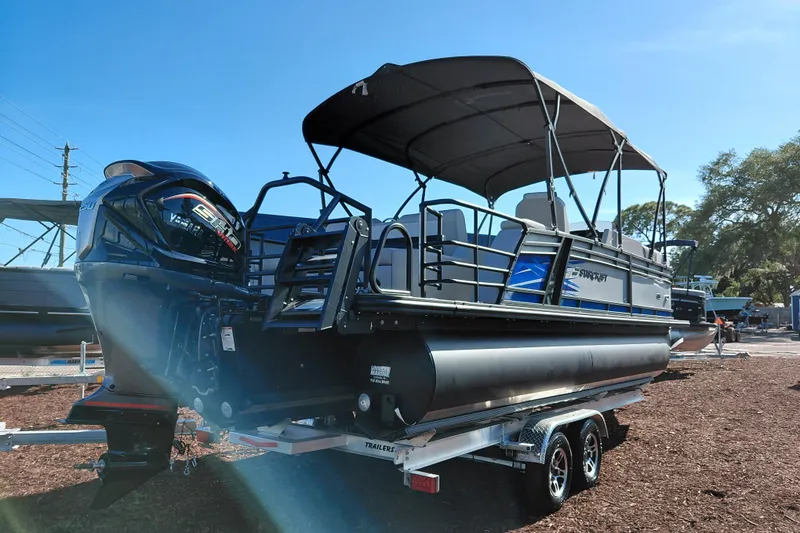 Slide: The Image of 2026 Starcraft SLS 3 Q DH pontoon boat with Yamaha engine on trailer. - 5