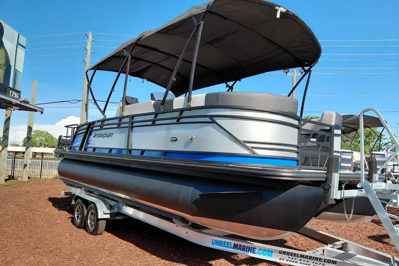 Slide: The Image of 2026 Starcraft SLS 3 Q DH pontoon boat on trailer, featuring sleek design and canopy. - 7