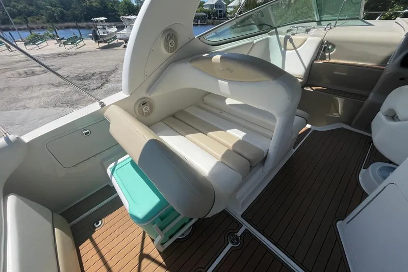 Slide: The Image of 2008 Sea Ray Sundancer 280 interior with beige seating and wood-style flooring. - 12