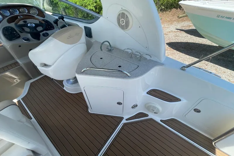 Slide: The Image of 2008 Sea Ray Sundancer 280 interior with helm, sink, and wood-style flooring. - 13