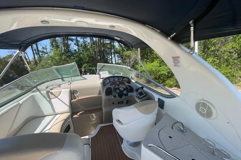 Slide: The Image of Interior view of 2008 Sea Ray Sundancer 280 boat cockpit with steering and seating. - 14