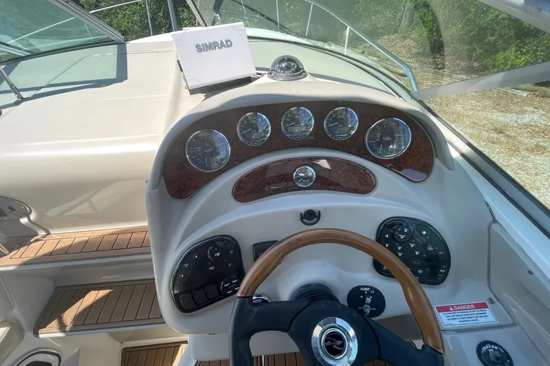 Slide: The Image of 2008 Sea Ray Sundancer 280 dashboard with wood accents and Simrad navigation system. - 16
