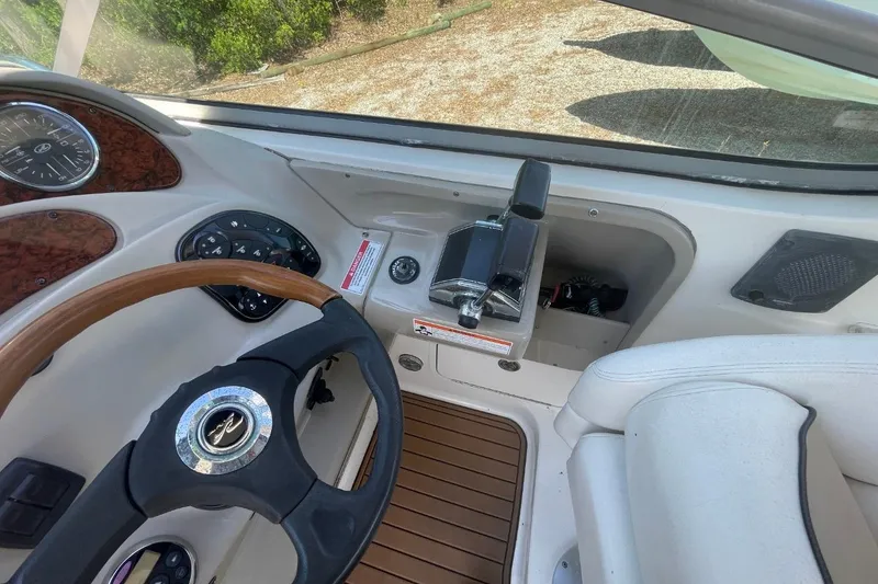 Slide: The Image of 2008 Sea Ray Sundancer 280 helm with steering wheel and control panel. - 18