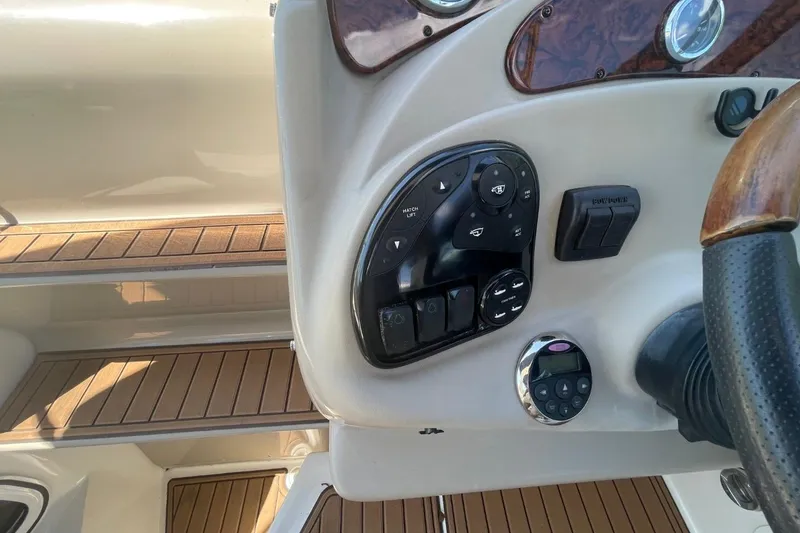 Slide: The Image of Control panel of a 2008 Sea Ray Sundancer 280 boat with wood accents. - 19